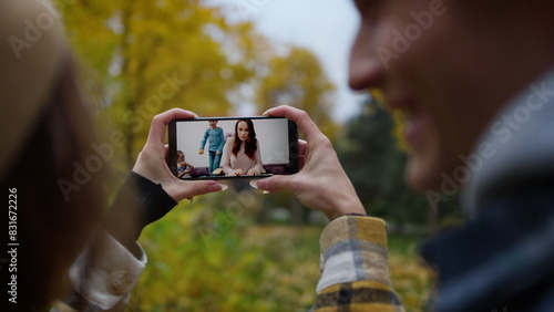 Young people calling sister online closeup. Smiling woman talking in smartphone