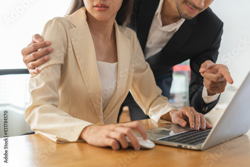 Disgusted asian young employee, pressure business woman uncomfortable, looking hand of boss or colleague male when touching her shoulder, embrace. Sexual harassment inappropriate at office work.