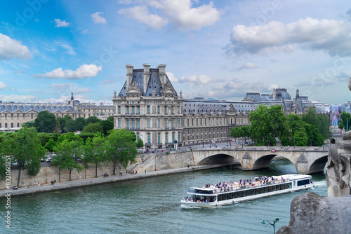 Pris cityscape with Louvre, boat and river Siene at summer, Paris, France