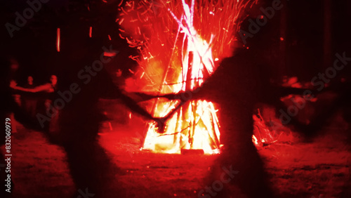 Huge fire at night and young people around. Pagan festival of Walpurgis night: bonfires, dancing wildly, witches. Figure of Witches Queen (HexenkР“В¶nigin). German legends, St. Walburgas and Satanism