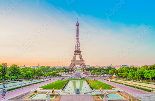 Paris Eiffel Tower and Trocadero garden at sunset in Paris, France. Eiffel Tower is one of the most famous landmarks of Paris., toned