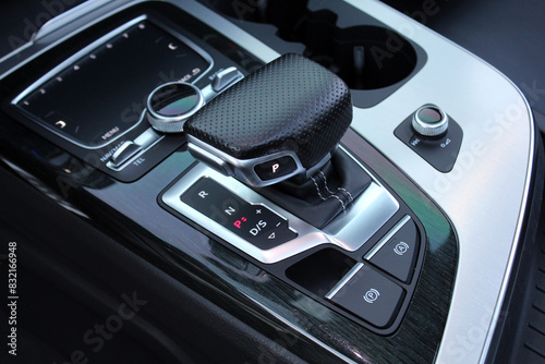 Selector automatic transmission with leather in the interior of a modern premium car. Gear shift lever for automatic transmission. Close up of the automatic gearbox lever.