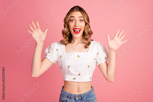Photo portrait of lovely young woman raise hands excited dressed stylish white garment hairdo isolated on pink color background