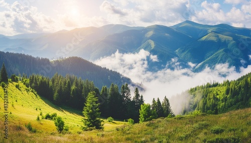 majestic landscape of summer mountains a view of the misty slopes of the mountains in the distance morning misty coniferous forest hills in fog and rays of sunlight travel background