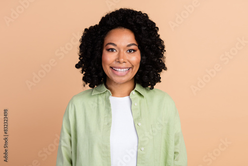 Photo of nice young woman beaming smile wear green shirt isolated on beige color background