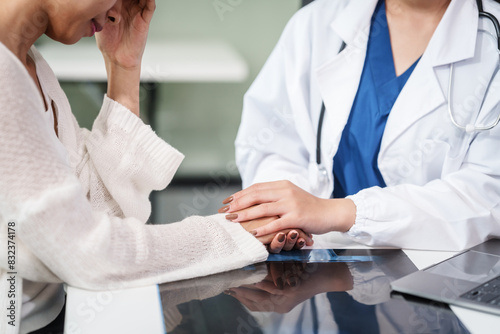 Asian female doctor specializing in psychiatry online consultations from desk, psychotherapy, diagnosis, treatment, counseling to psychiatric patients disorders depression, anxiety, schizophrenia.