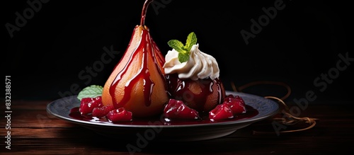 Plate of tasty poached pears in wine sauce on dark background. copy space available