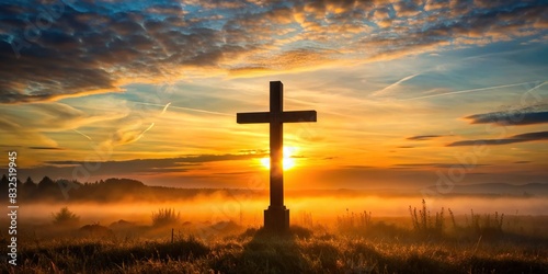 Silhouette of battlefield cross at sunrise with soft morning light