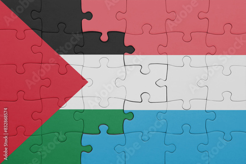 puzzle with the colourful national flag of luxembourg and flag of palestine.