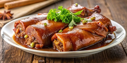 Traditional braised pork feet on a white serving plate with visible gelatinous texture and rich flavors