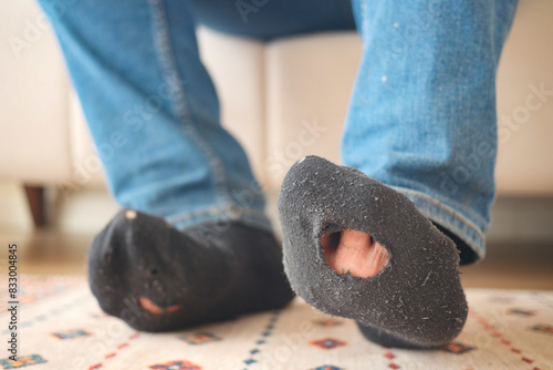 men feet with dirty socks while sitting on sofa 