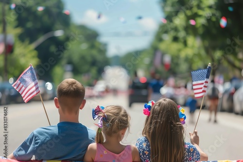 Family enjoying a sunny day at a patriotic parade, waving American flags and celebrating on the decorated city street.