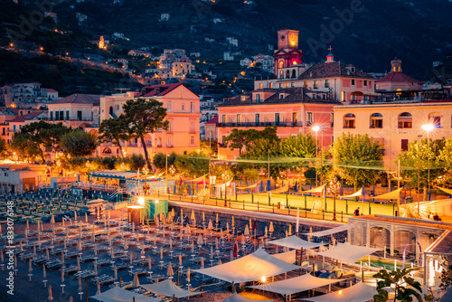 Illuminated night cityscape of Minori town. Fantastic sunset on the Mediterranean cost. Exciting evening scene of Italy, Salerno region, Europe. Vacation concept background.