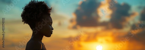 Portrait of young african american woman with afro hairstyle on the beach at sunset