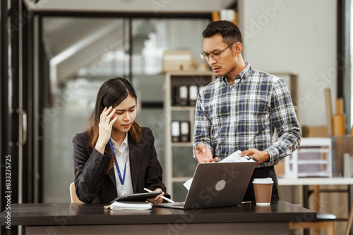 Young businesswoman and other Asian individuals are seen working at desks. Accountability, faultfinding, negligence, and other aspects of recruitment, staffing, and talent management being discussed.