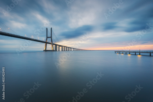 Vasco da Gama bridge and pier over tagus river in Lisbon (Portugal), before sunrise