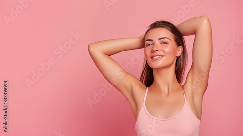 beautiful woman with smooth clean skin raising hands showing perfect shaved armpit isolated on pink background with copy space for text