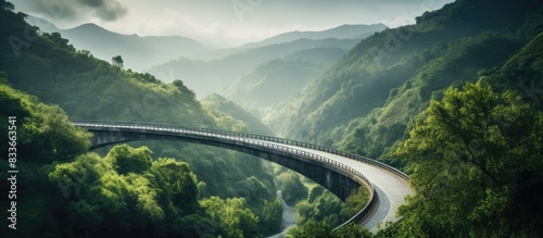 Road in the green mountains with an iron bridge. Creative banner. Copyspace image