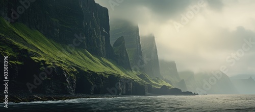 The towering sea cliffs provide a dramatic backdrop for the serene landscape in the copy space image.