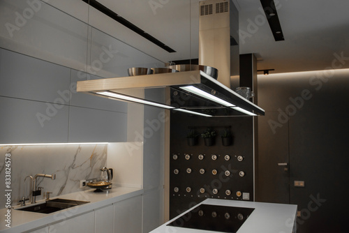 Steel suspended kitchen range hood on a kitchen