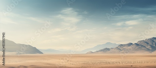 A scenic bare mountain range and sandy valley desert in the Middle East or Africa make a captivating landscape for photography with ample copy space image in a horizontal frame.