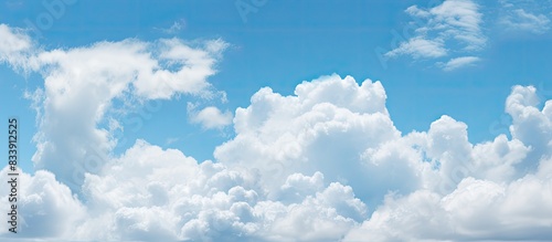 A cloudy blue sky with dramatic tiny clouds floating, creating a fluffy cloud texture against a blue sky background, ideal for copy space image.