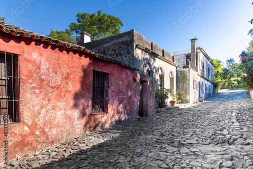 View down one cobblestone street Calle de Solis lined with historic buildings in historic quarter of Colonia del Sacramento in Uruguay a UNESCO World Heritage Site along the Río de la Plata