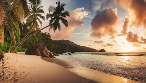 panoramic view of beautiful beach at sunset with coconut palm tree sea and beautiful rocks beau vallon beach mahe island seychelles