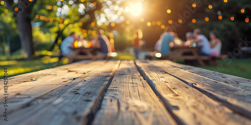 Empty wooden table with space to place product or advertising, background family reunion at the table, in the garden