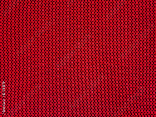 Red breathable porous poriferous material for air ventilation with holes. Sportswear material nylon texture.