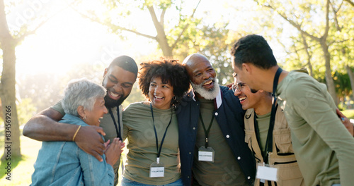 Huddle, happy and group of volunteer outdoor with collaboration, teamwork and solidarity for charity work. Hug, smile and people or ngo in park with cooperation, community and together for support