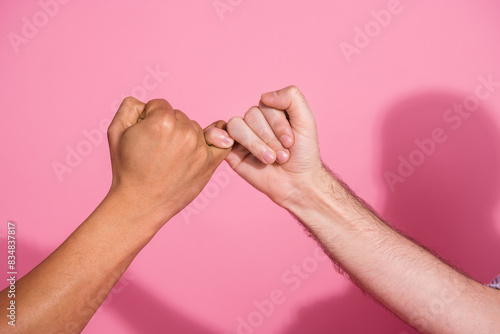 Photo of two diverse people make promise gesture swear isolated pastel color background