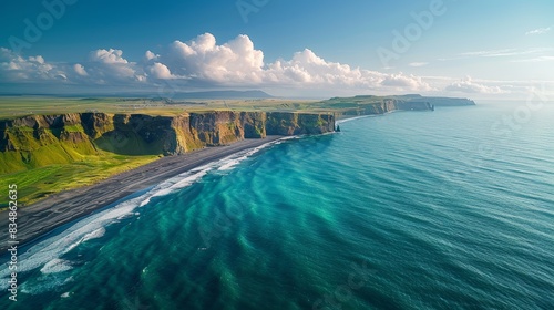 Expansive aerial shot of dramatic coastal cliffs against turquoise waters
