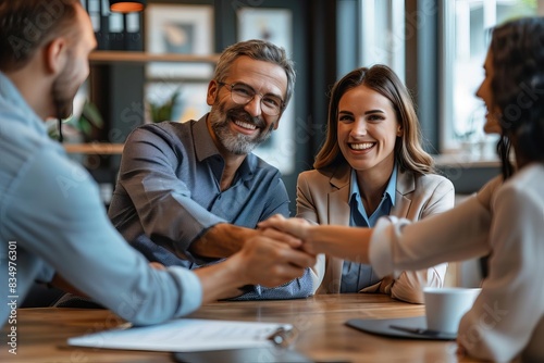 A real estate agent closing a deal with happy clients focus on success, celebration theme, dynamic, overlay, office backdrop