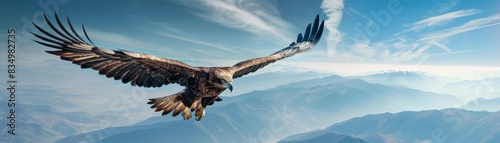 Majestic eagle soaring through a clear blue sky with mountains in the background, showcasing the beauty of wildlife and nature.