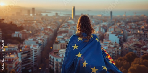A young woman with European flag looking at the city.