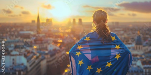 A young woman with European flag looking at the city.