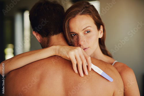 Woman, man and sad with hug for pregnancy test in bedroom, thinking and worry with anxiety in home. Couple, infertility and embrace for support, empathy and care for results in morning in apartment