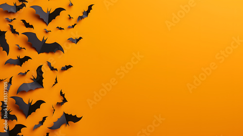Paper cut bats on orange background, minimalistic halloween concept, copy space area