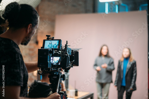 Director of photography with a camera in his hands on the set. Filming process indoors, studio