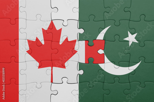 puzzle with the colourful national flag of pakistan and flag of canada.