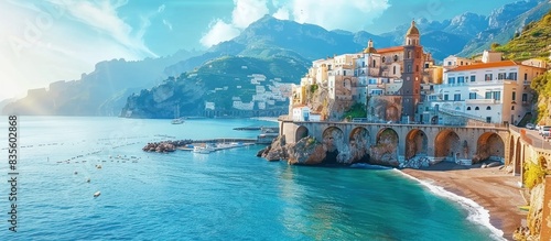 panoramic view of the coast with clear blue water and buildings on the shore, sunny day, sunlight reflecting off sea surface, bright colors