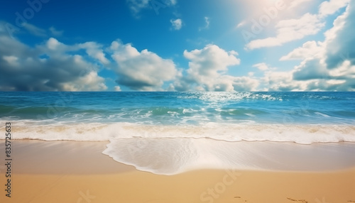 Beautiful beach landscape with blue sky and white clouds and gentle waves lapping at the shore