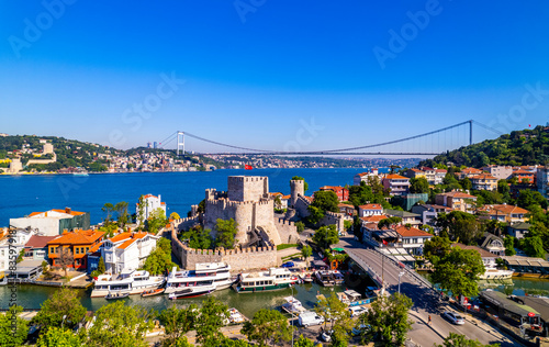 Fatih Sultan Mehmet Bridge and Anadolu Hisari (Anatolian Fortress) in Istanbul, Turkey. Beautiful Istanbul bosphorus landscape. Drone shot.