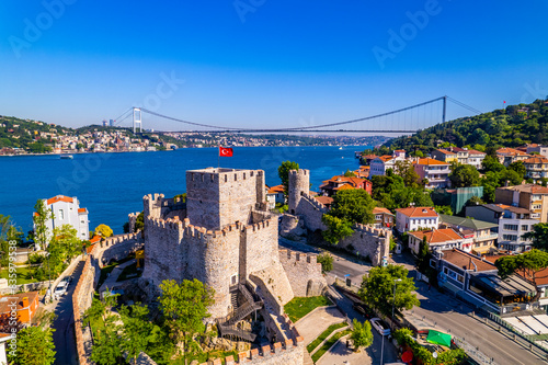 Fatih Sultan Mehmet Bridge and Anadolu Hisari (Anatolian Fortress) in Istanbul, Turkey. Beautiful Istanbul bosphorus landscape. Drone shot.