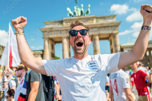 English football soccer fans in downtown Berlin at the Brandenburg gate celebrate the national team, Three Lions