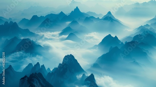 Ethereal blue mountain ridges gracefully emerge from a dense sea of fog, creating a serene, mystic landscape.