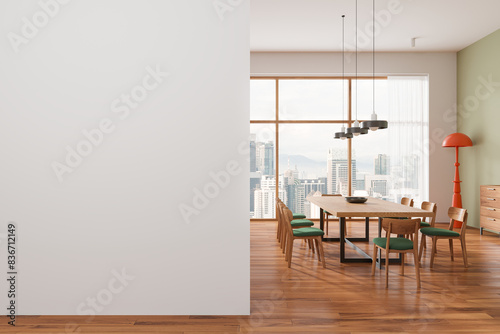 Modern dining room with large empty wall on the left, wooden furniture, and wide windows overlooking a cityscape, concept of interior design. 3D Rendering