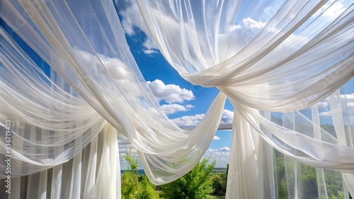 White sheer curtains billowing in the breeze