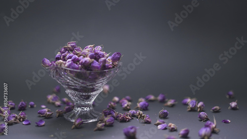 Dried damask rose buds around the crystal container